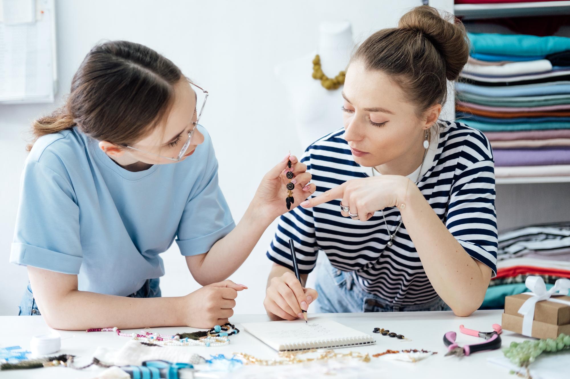 Instructor guiding student stitching